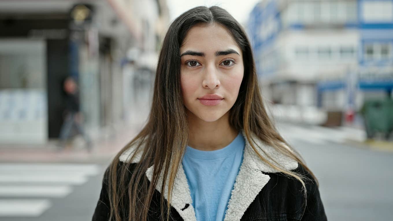 What Almost Everyone Gets Wrong About Manifestation That Keeps It From Working Young woman standing with serious expression at street