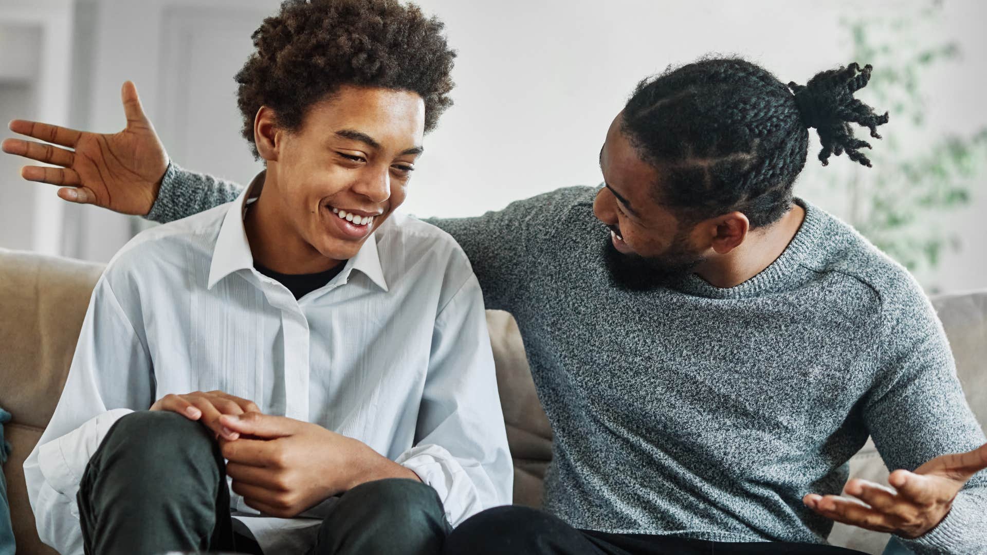 Man talking to his happy teenage son