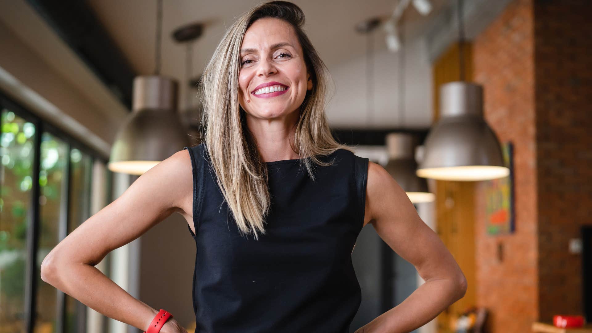 Confident woman smiling alone at home