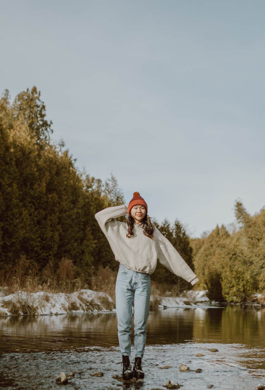 Woman dreaming of standing in a river which is a sign of financial success