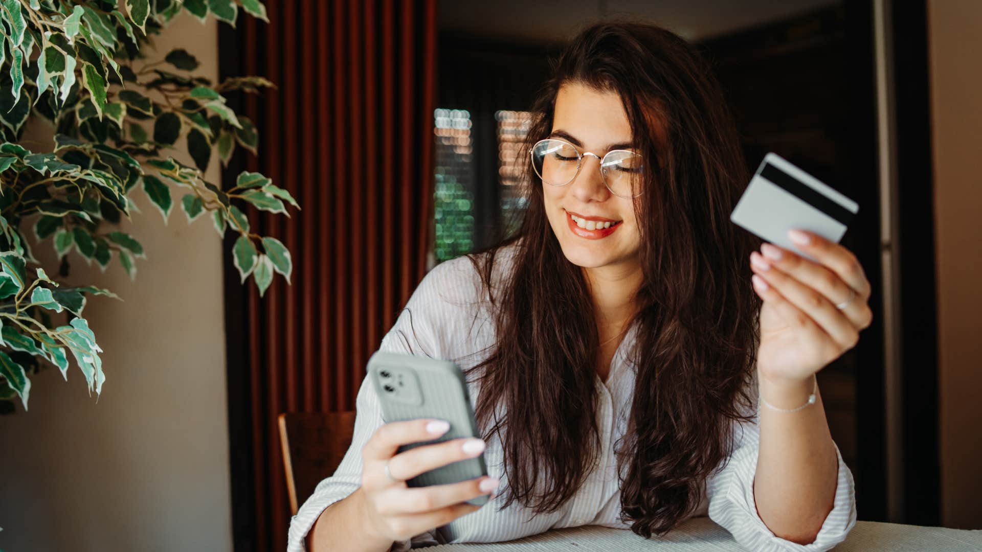 woman using credit card on phone