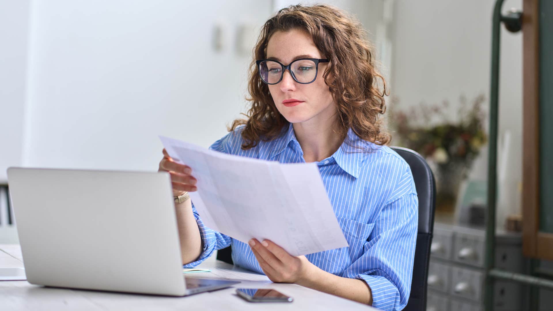 woman looking at finances on laptop