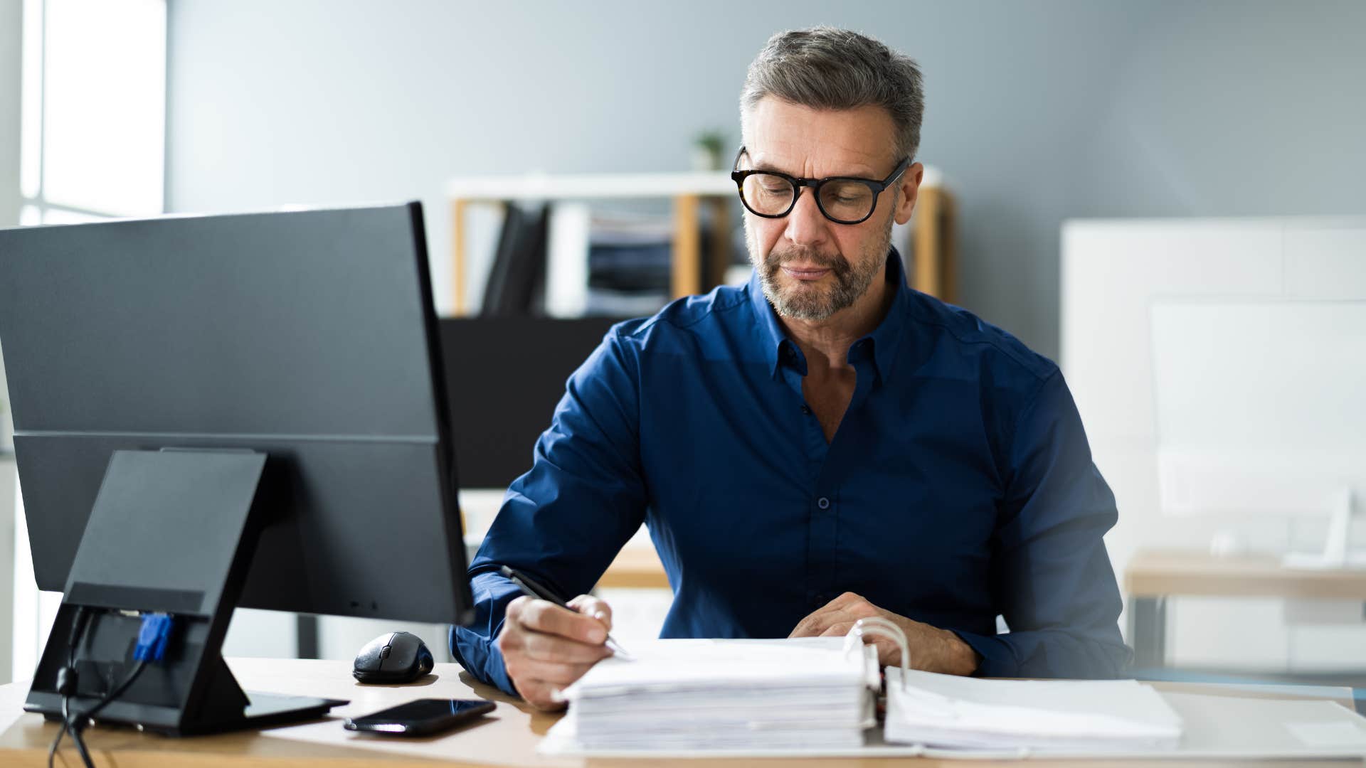 Man looking at papers on his desk