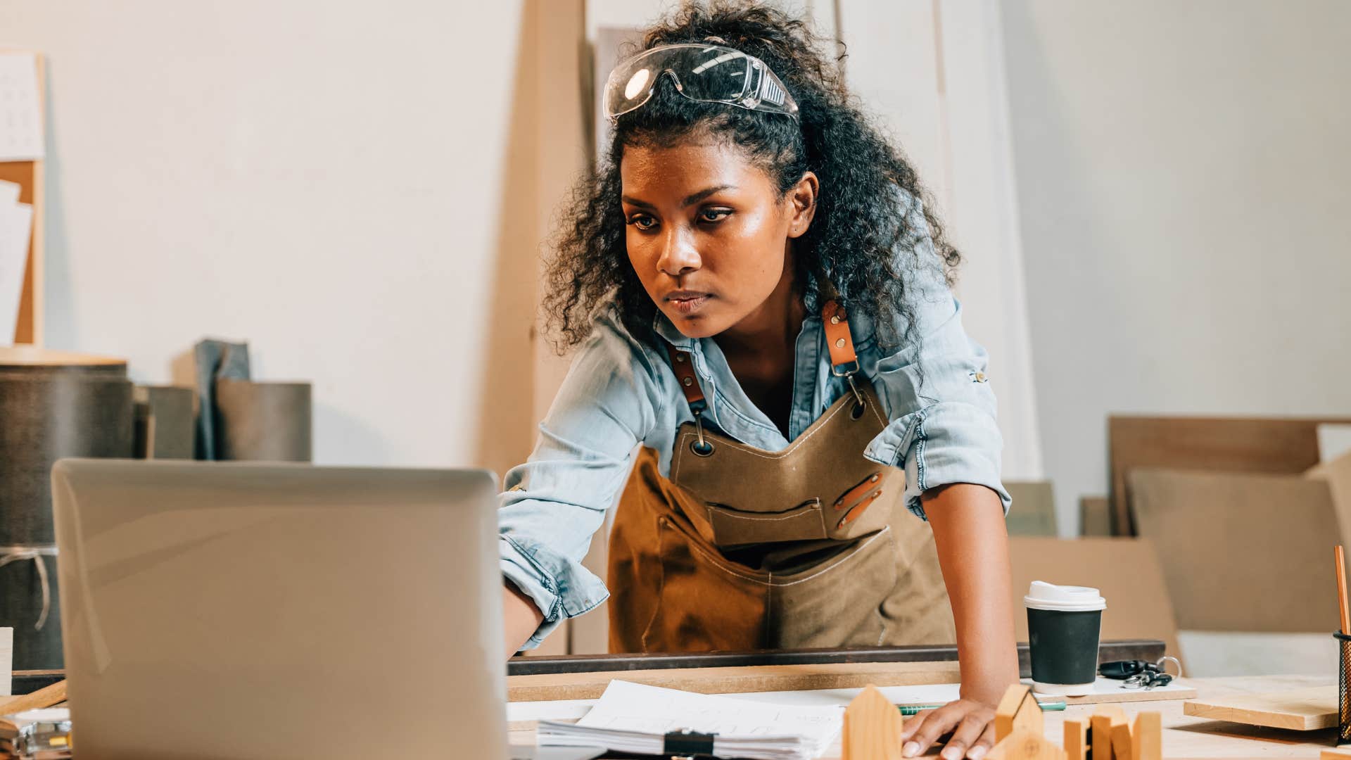 Woman working on a job site typing on her computer