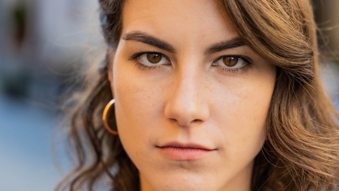 Quiet Behaviors Of A Person With Evil Intentions, According To Psychology Angry woman looking directly at the camera.