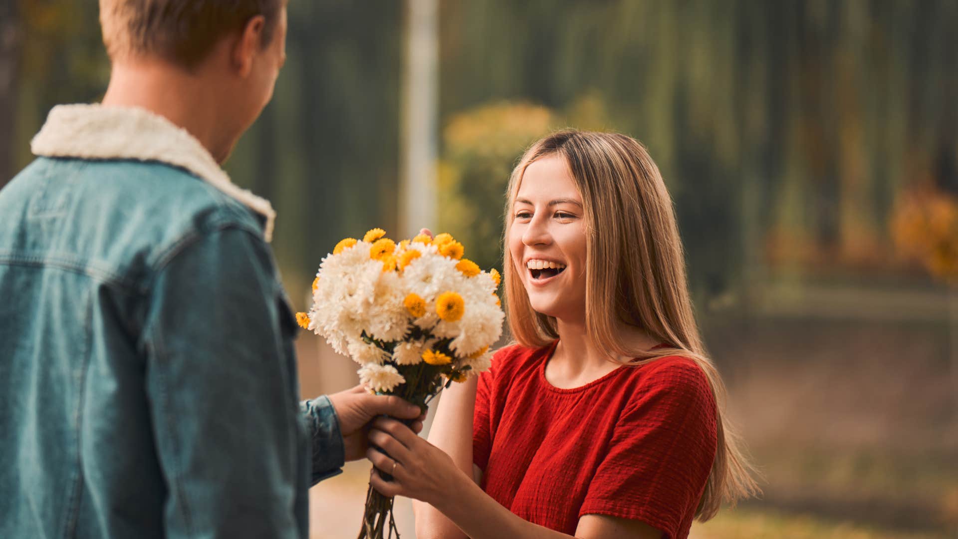 woman receives flowers from her partner showing his affection