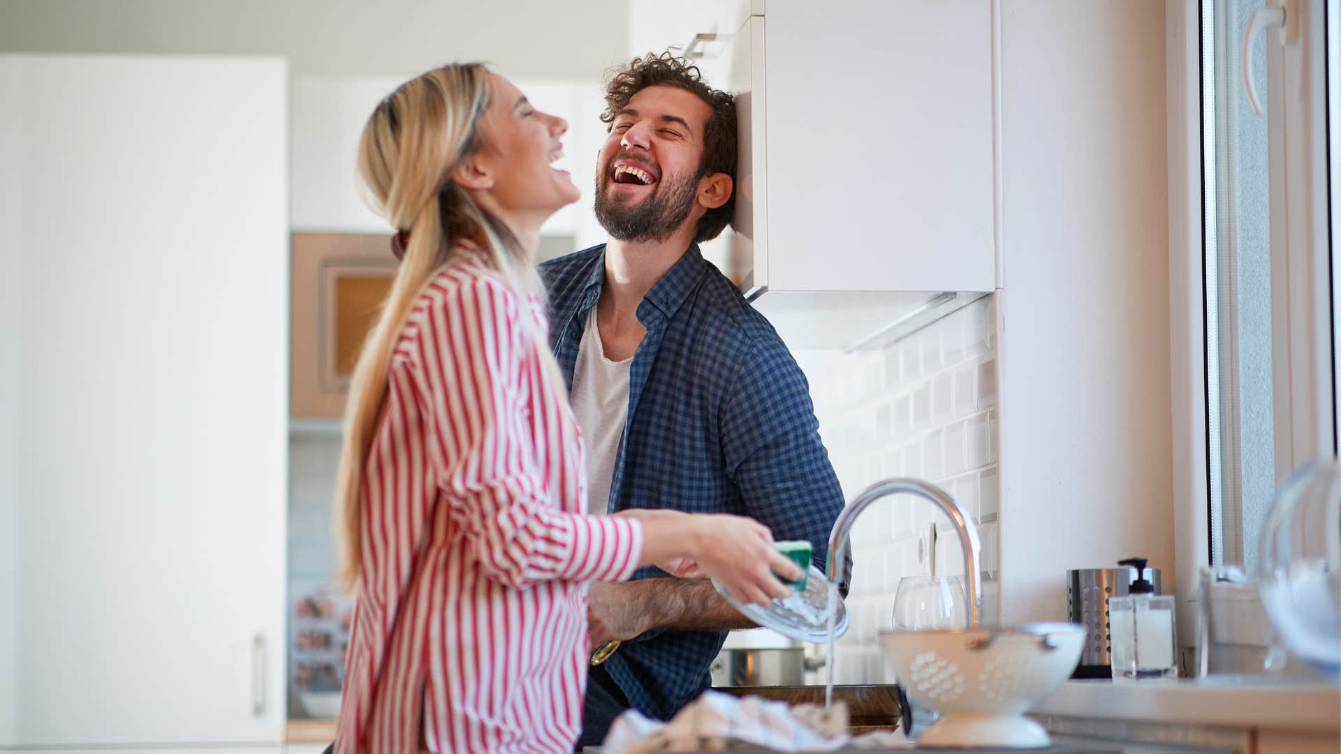couple laughs in the kitchen showing their sense of humor