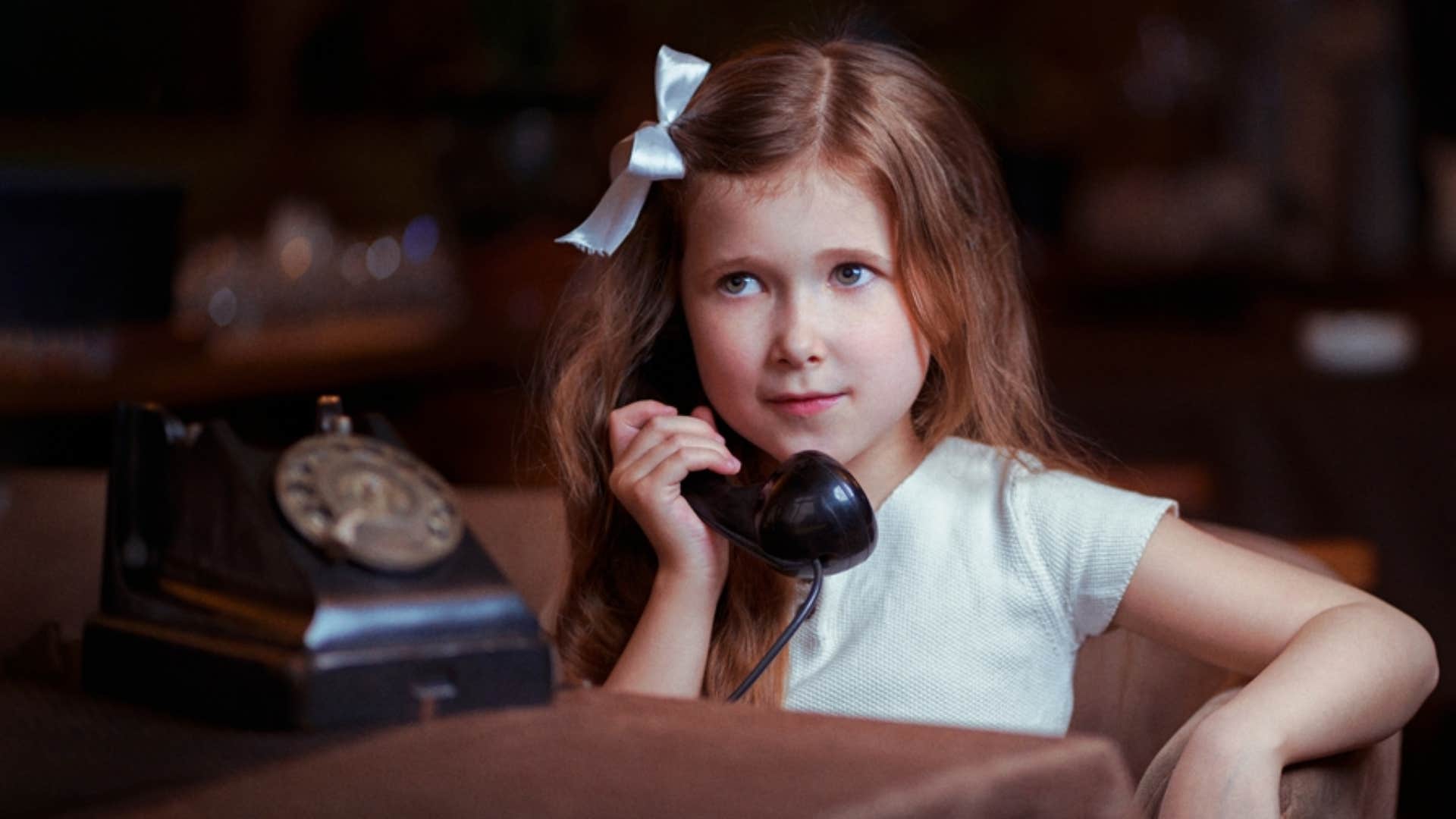 child using rotary phone