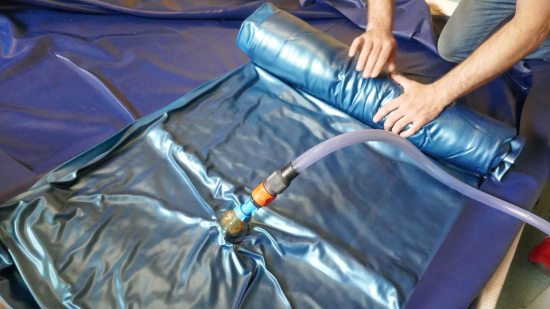 man filling up waterbed