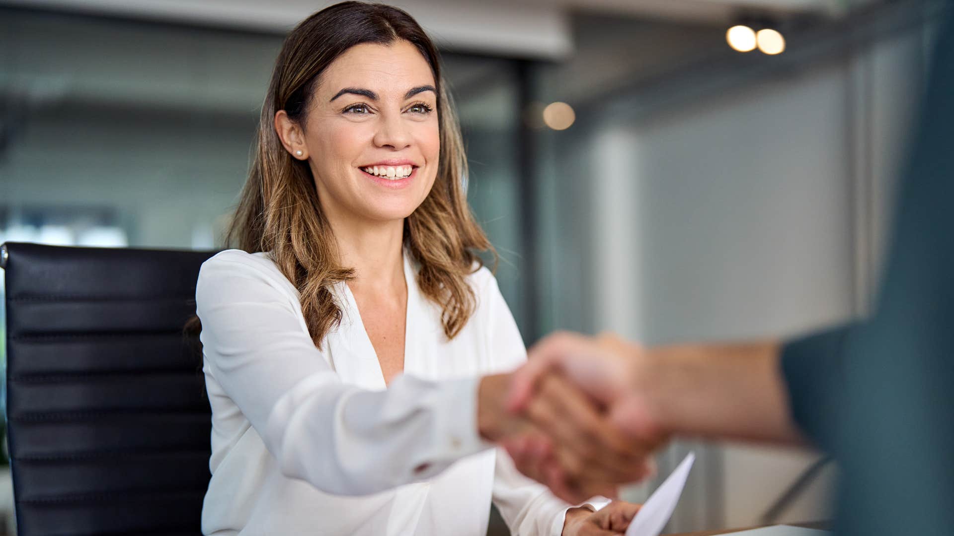 woman shaking a man's hand greeting him