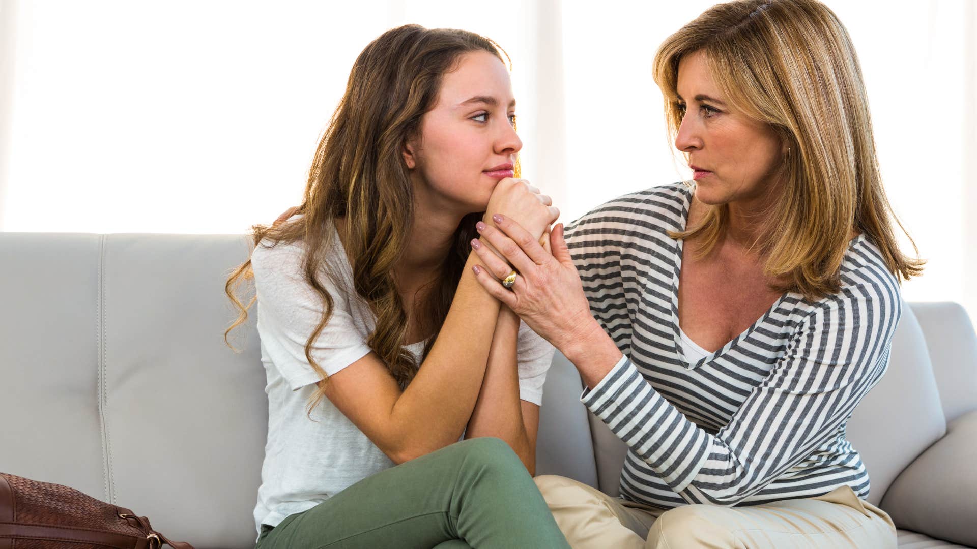 woman comforting her teenage daughter