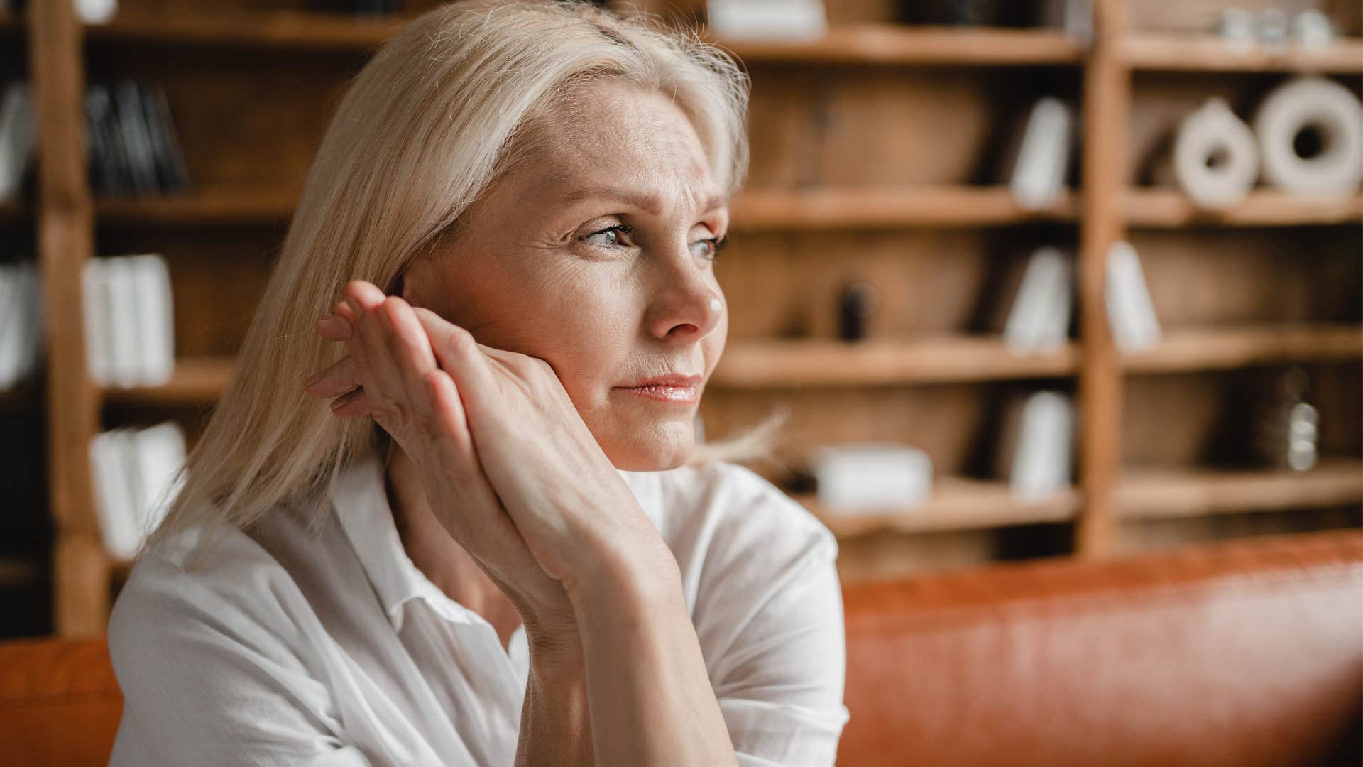 tired woman looking out a window