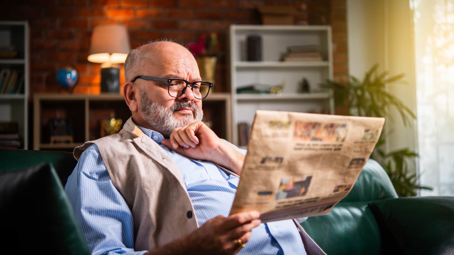 An elderly man gets rid of his old newspapers