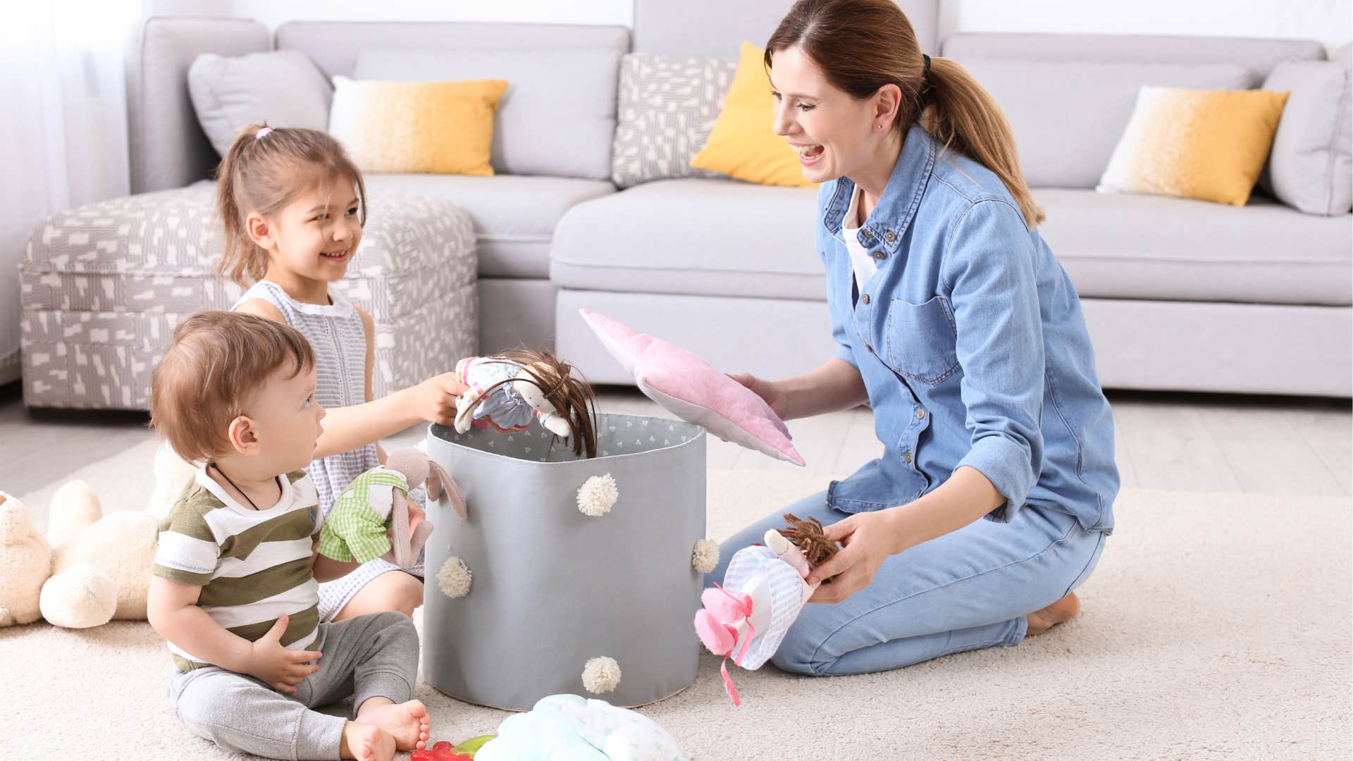 A mother helps her two children get rid of their unused toys