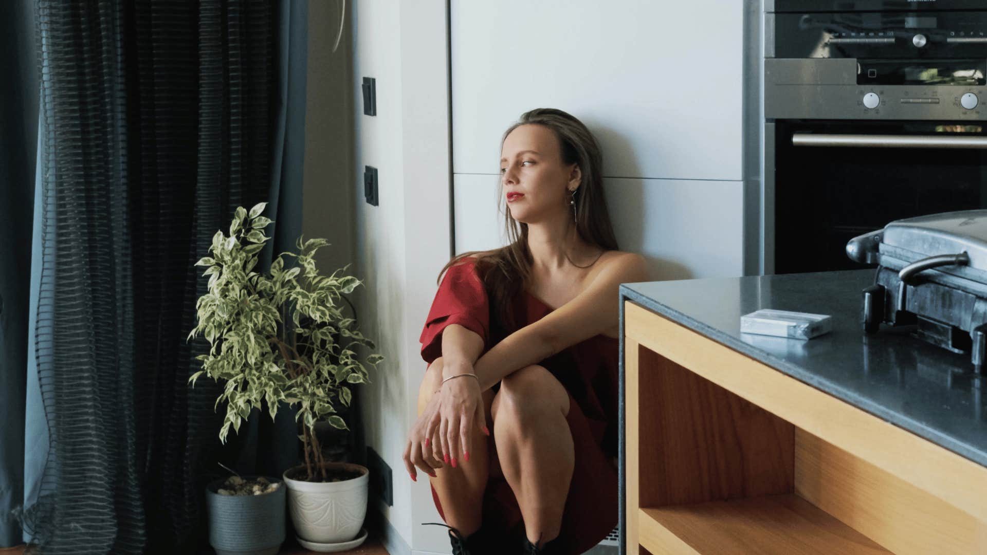 upset woman sitting on floor