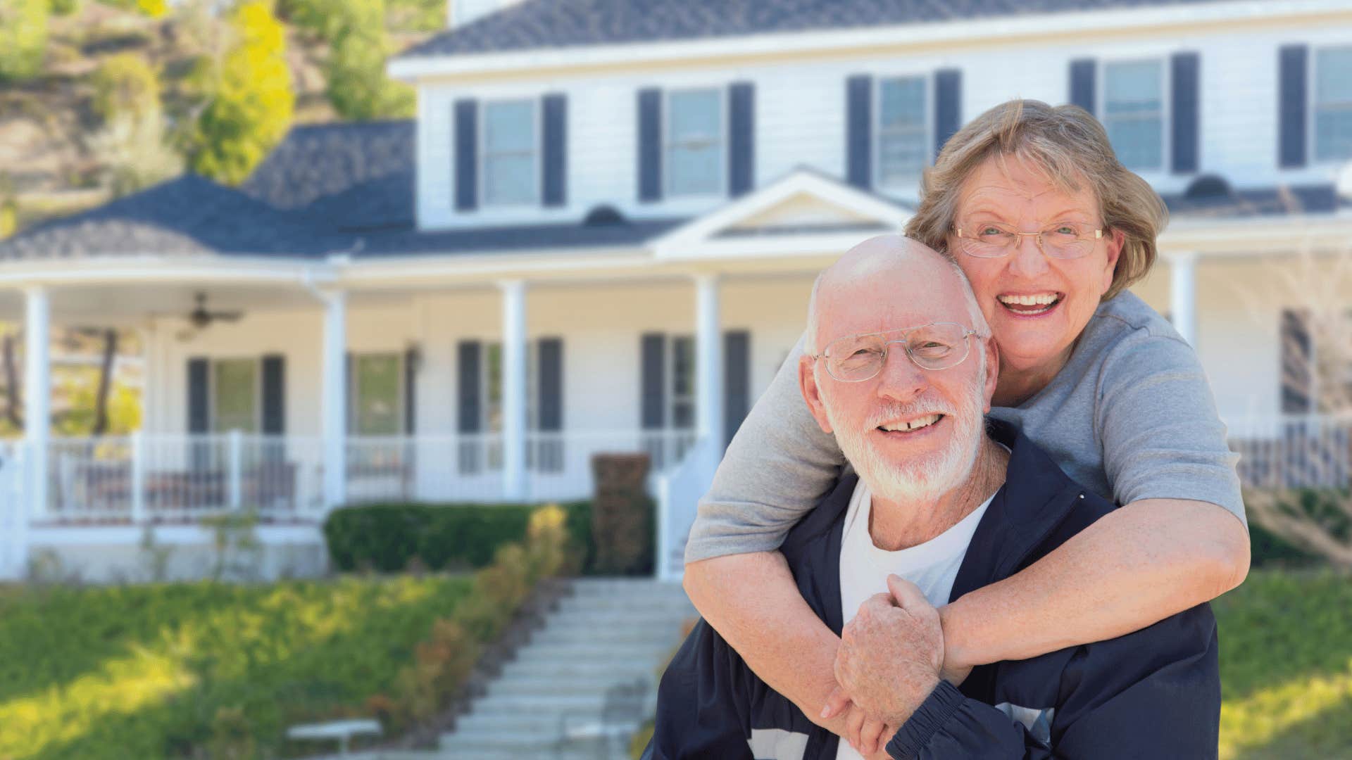 boomer couple in front of their home
