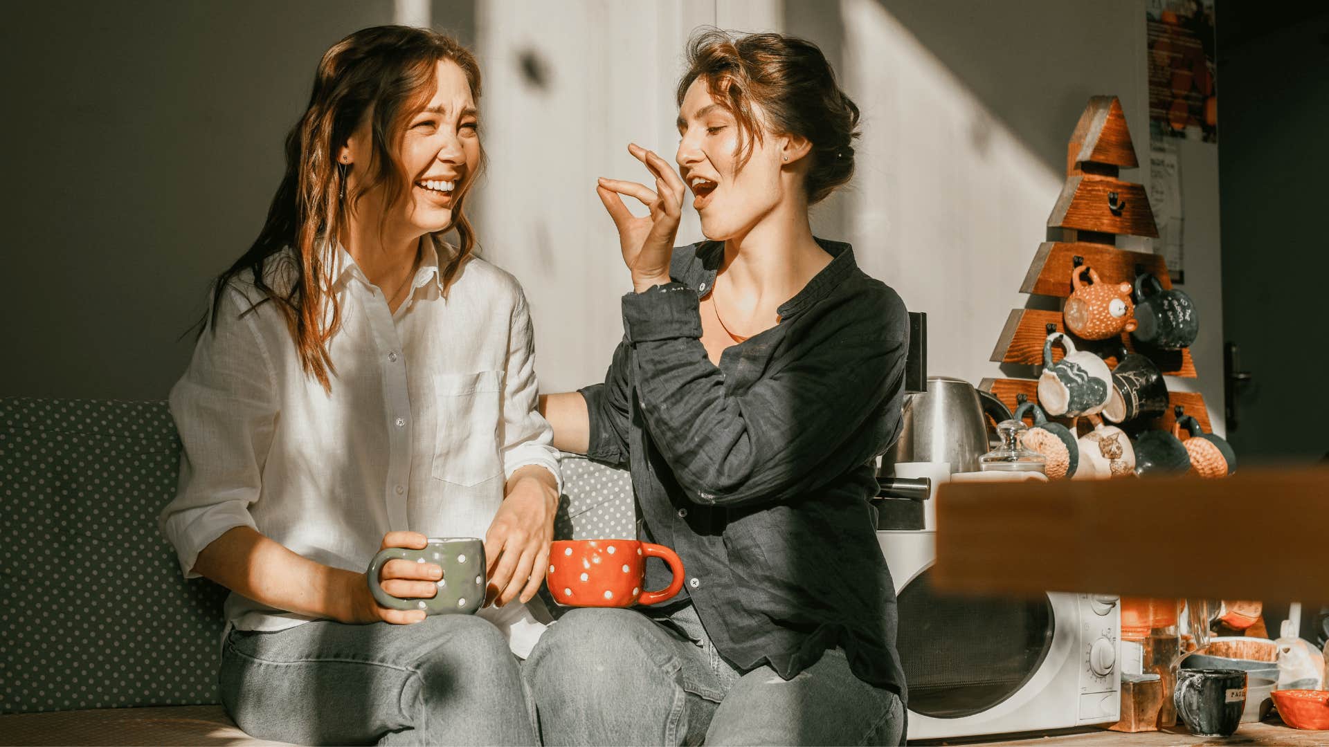 woman eating with friend while laughing 