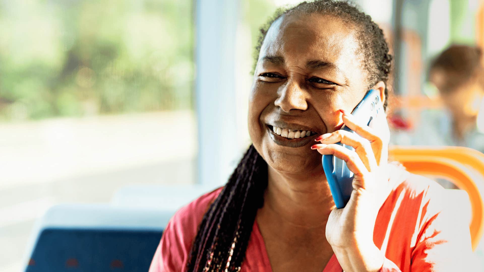 happy boomer woman talking on the phone
