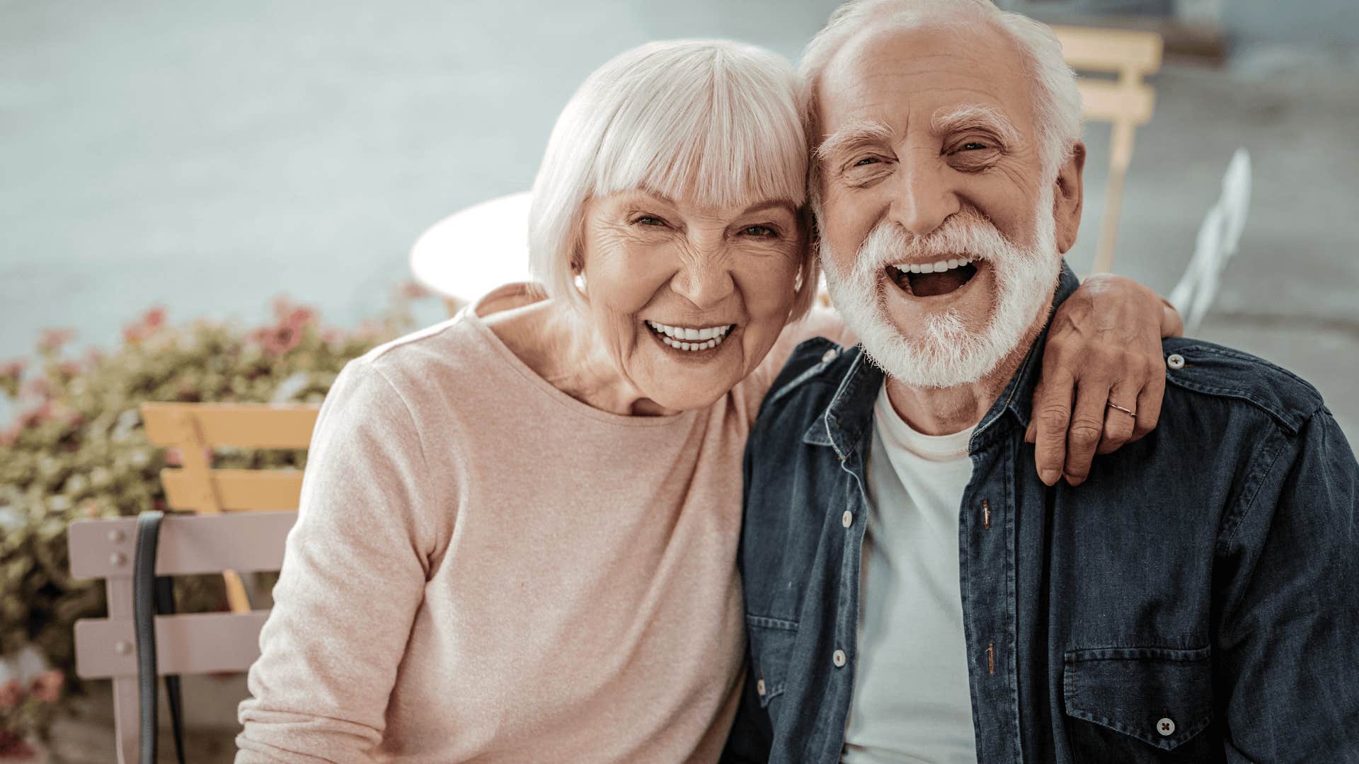 boomer couple smiling and hugging