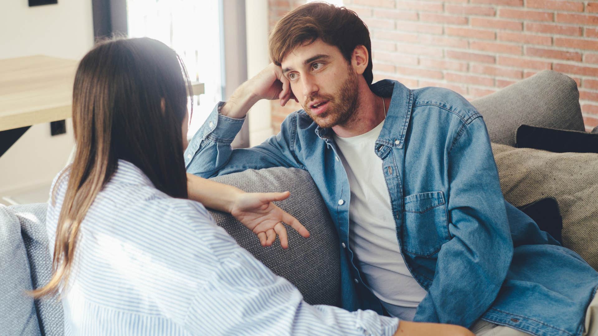 Upset man talking to his partner on the couch saying i feel you