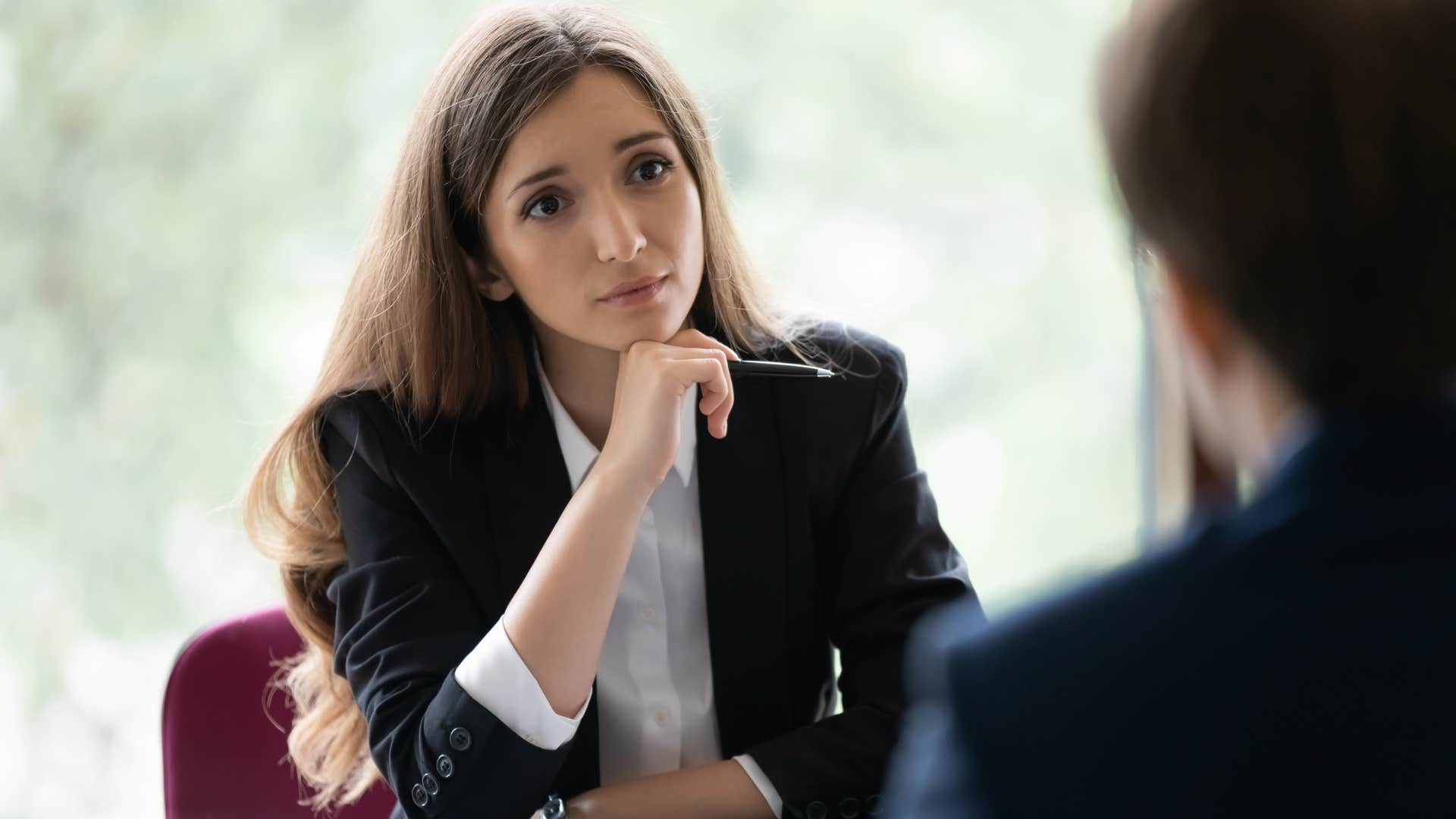 Upset woman looking at a man in her office saying it's impossible