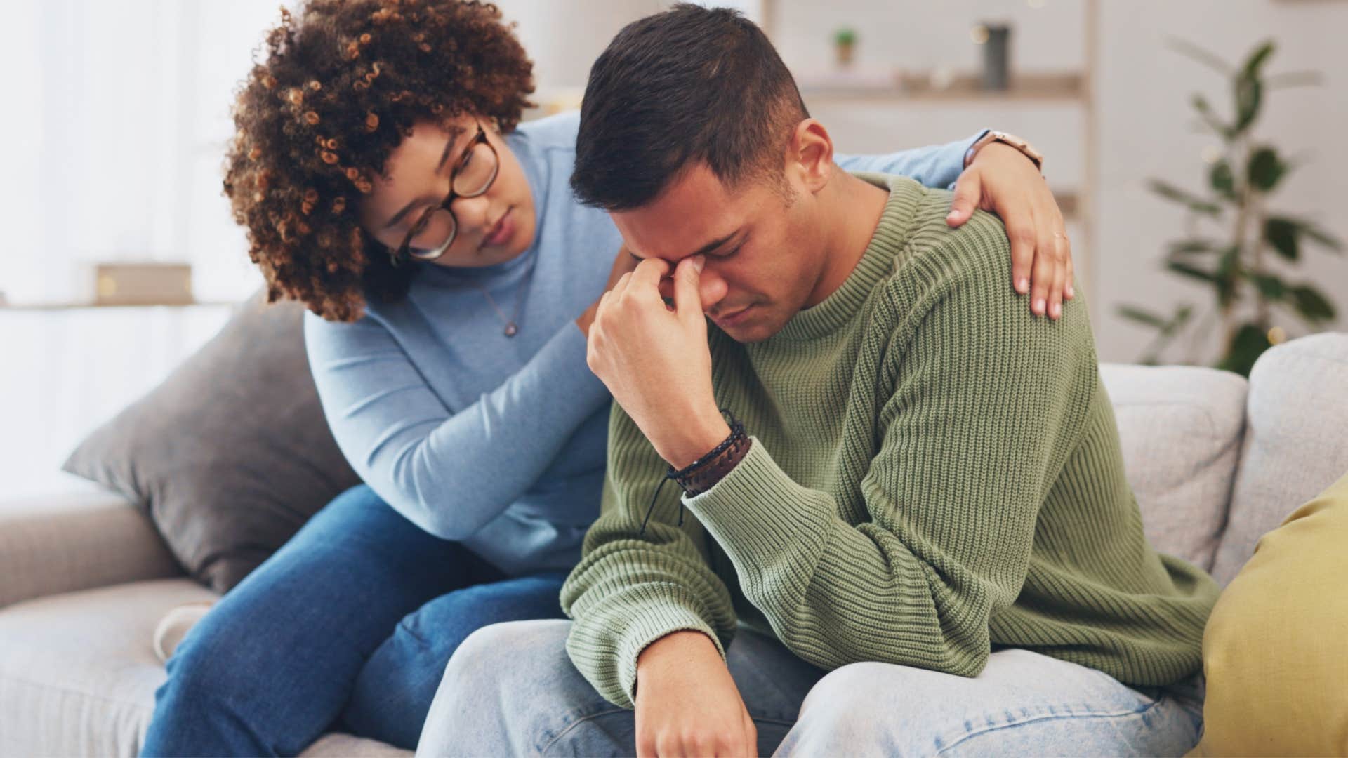 Woman saying you're being insensitive her upset partner on a couch