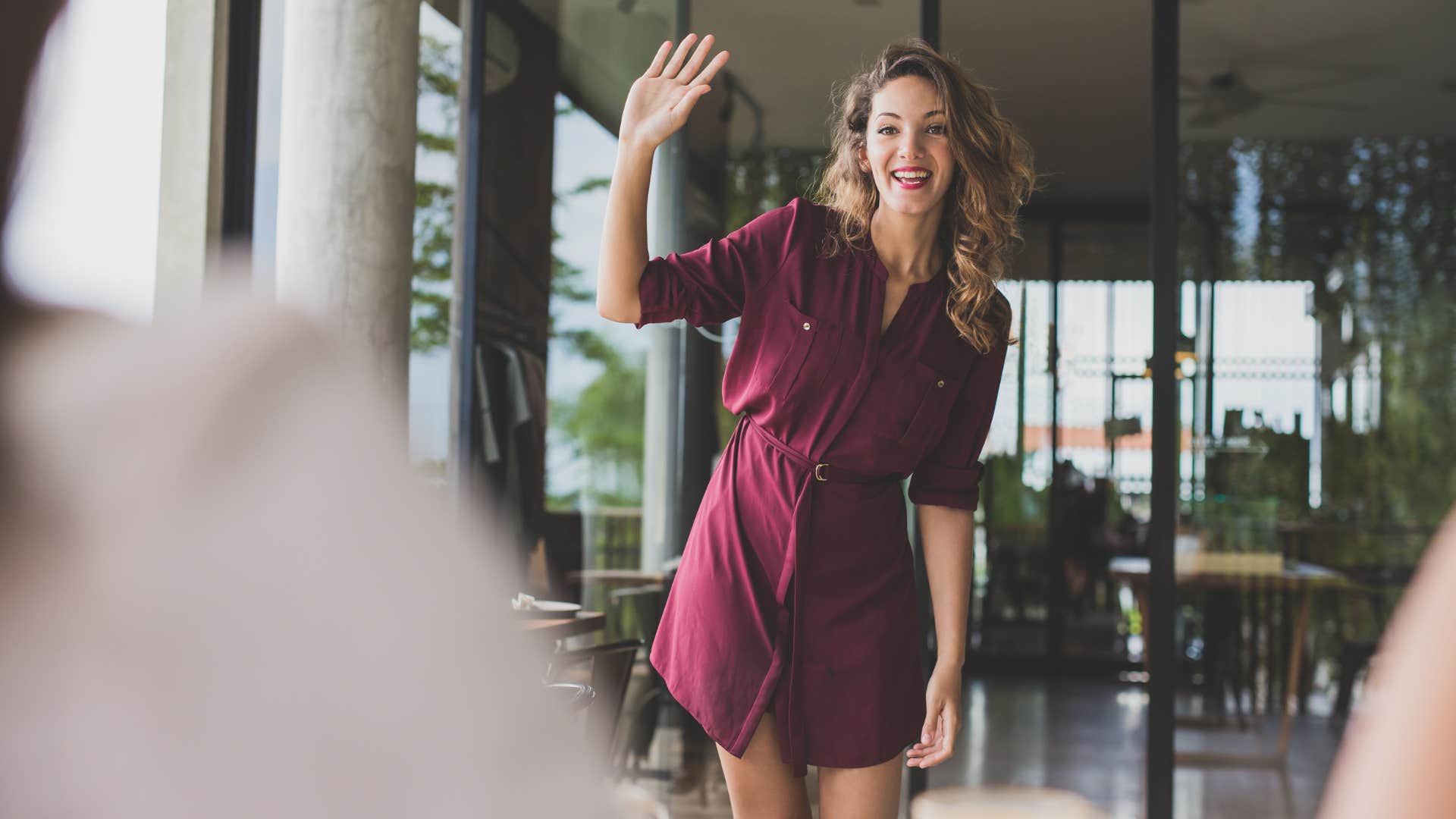 woman greeting people as she enters the room