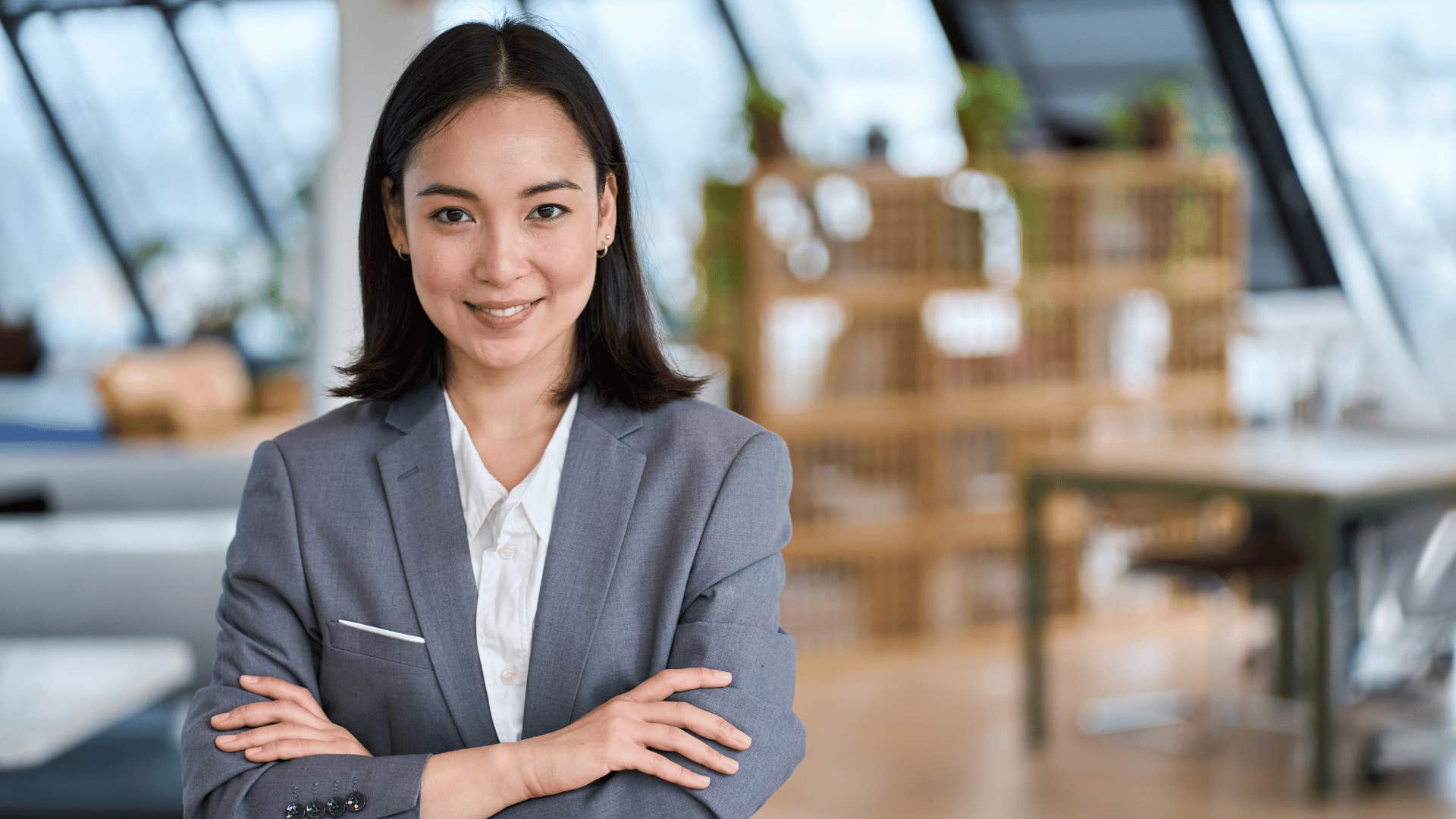 professional woman with arms crossed in control