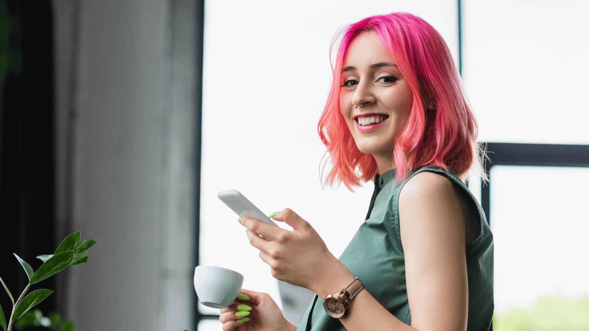 confident woman with pink hair smiling