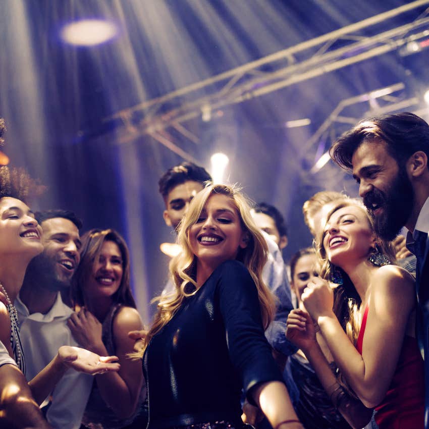 irresistible confident woman dancing at club