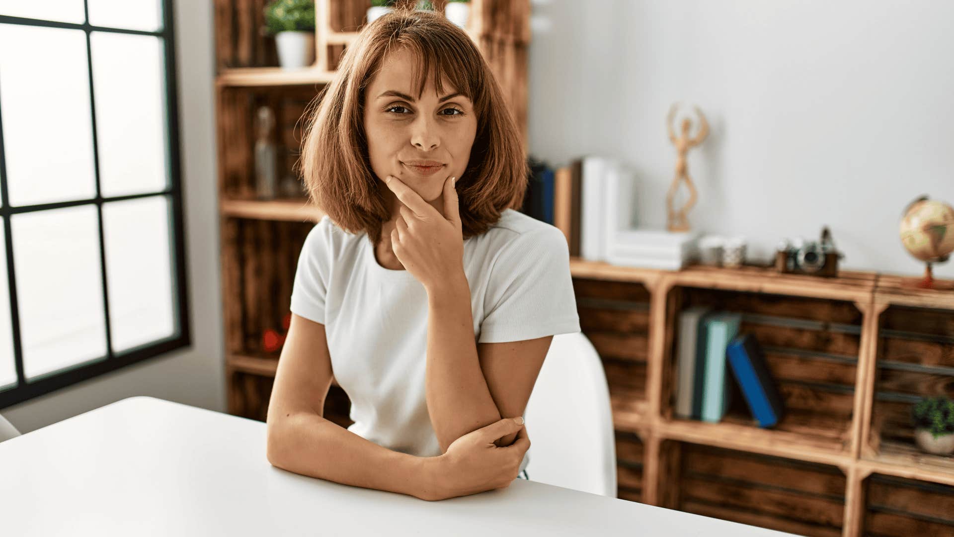woman sitting at table thinking