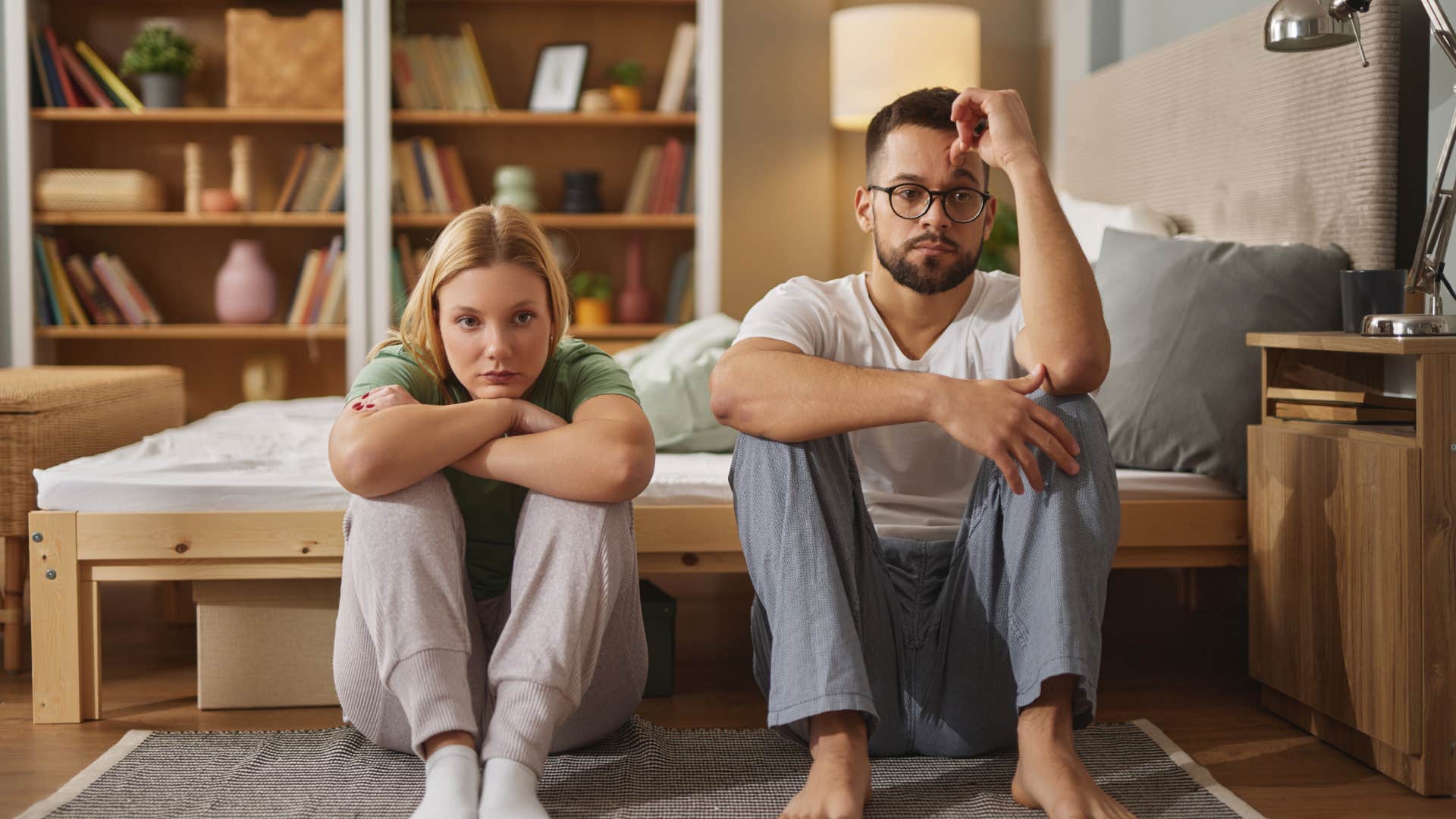 upset couple sitting next to each other avoiding conflict