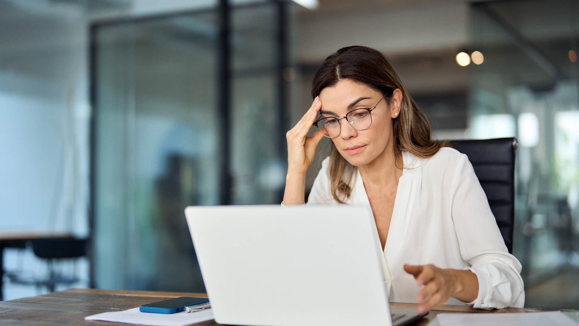 overworked woman on laptop