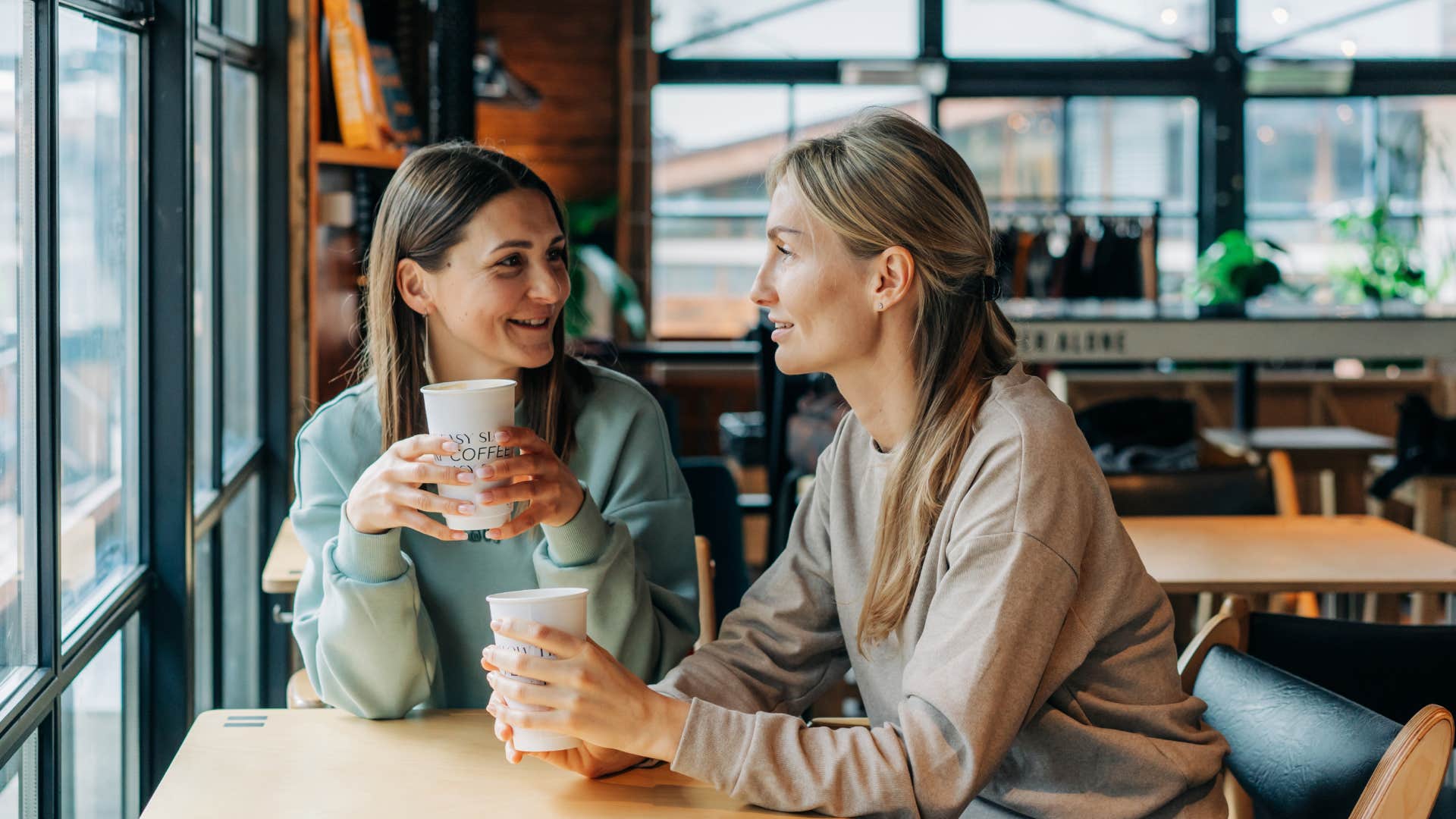 two friends talking in coffee shop