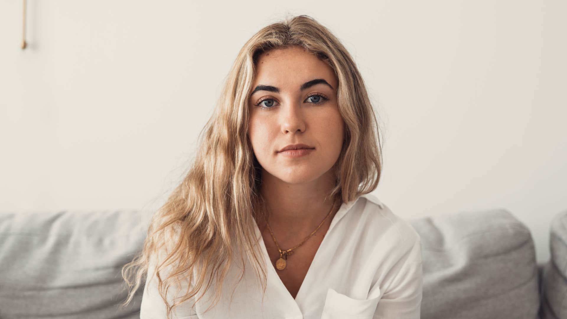 selfless woman sitting on couch