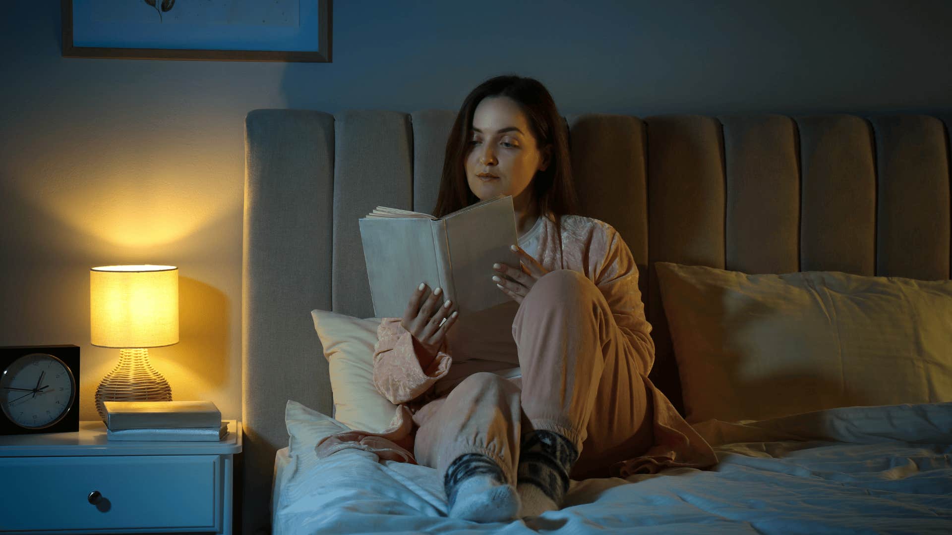 woman reading in bed affected by brutal dating truths millennials swear by