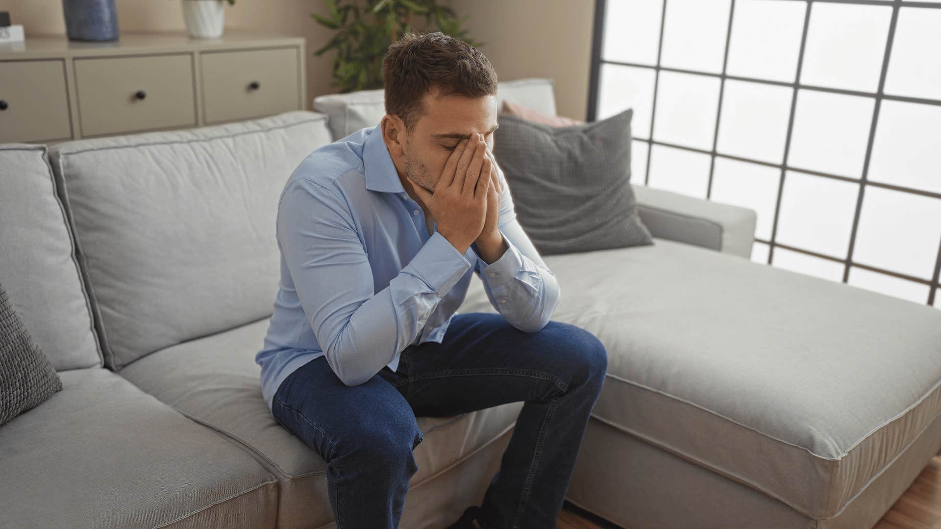 anxious man sitting on couch