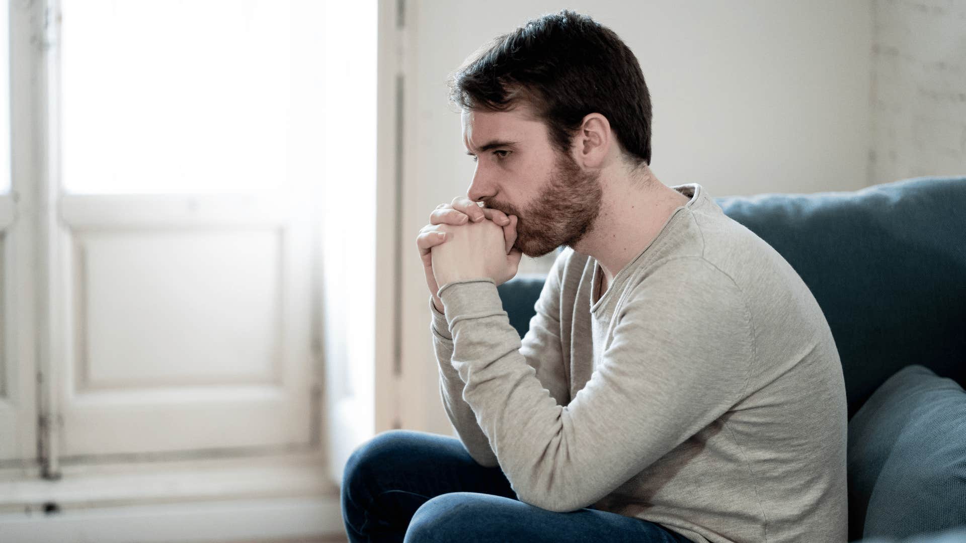 sad man sitting on couch