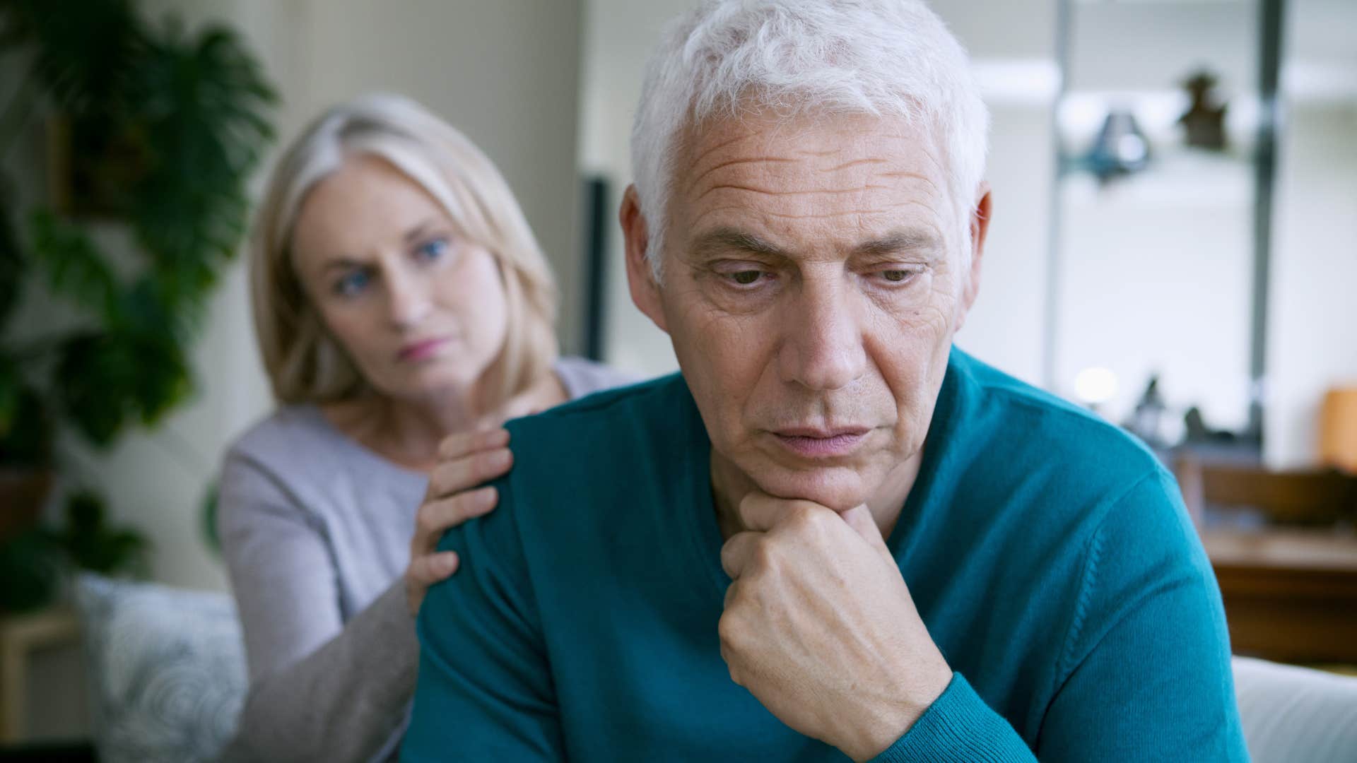 upset older man turned away from his wife