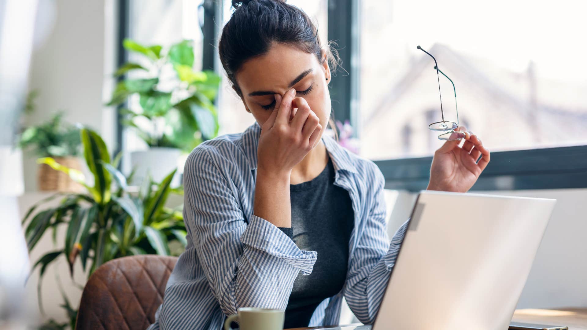 stressed woman holding her forehead