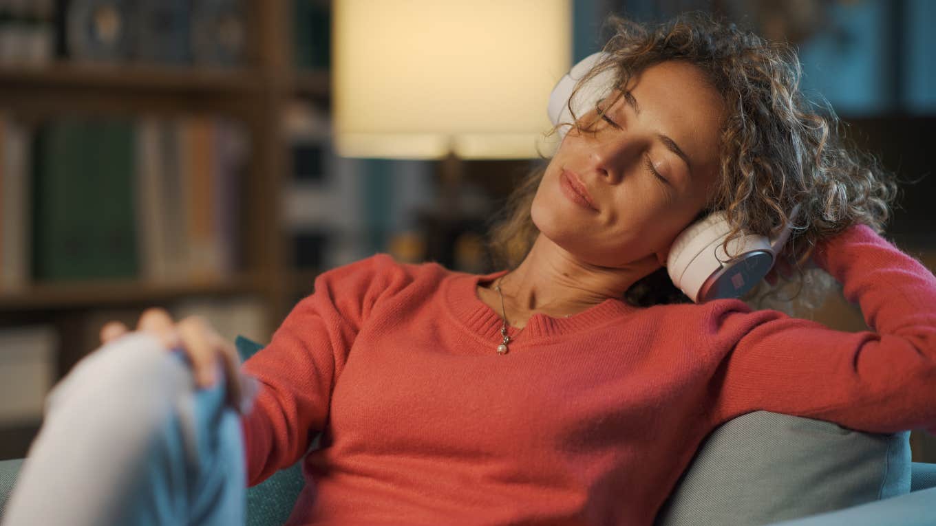 peaceful woman listening to music at night