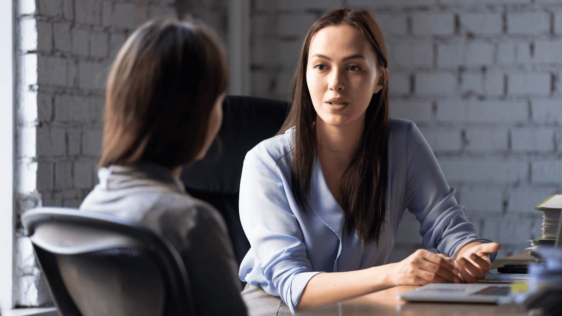 woman maintaining eye contact with colleague