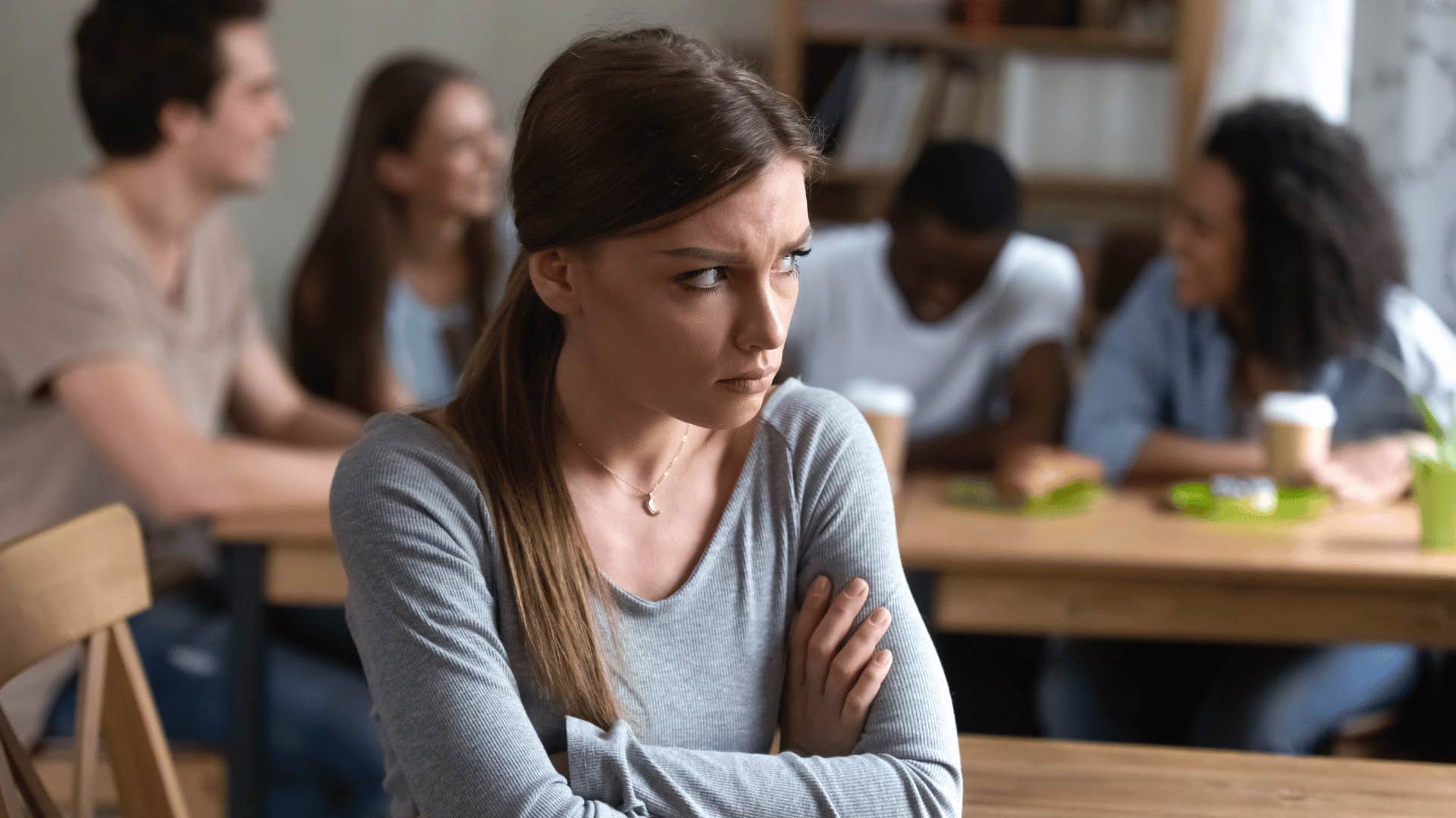 stressed and sad woman ostracized from group