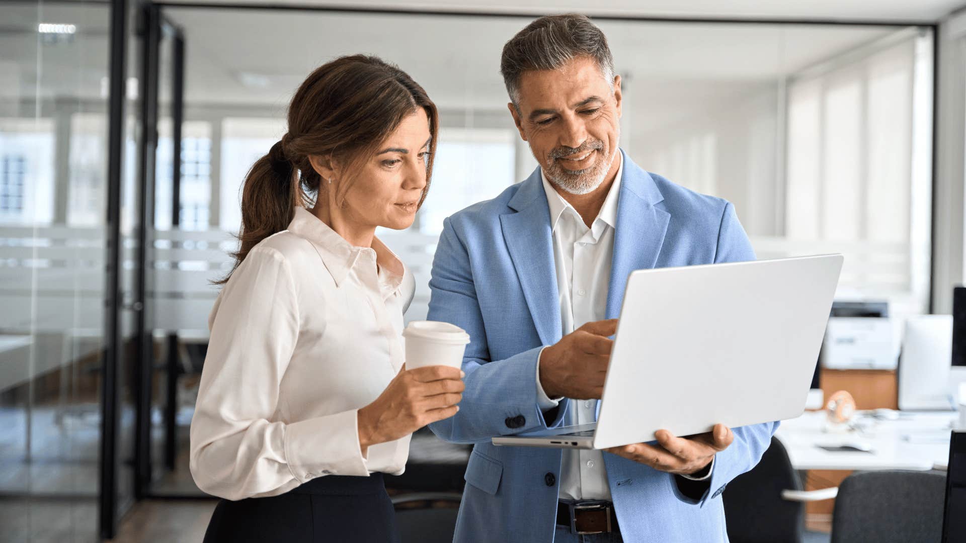 boss showing employee laptop
