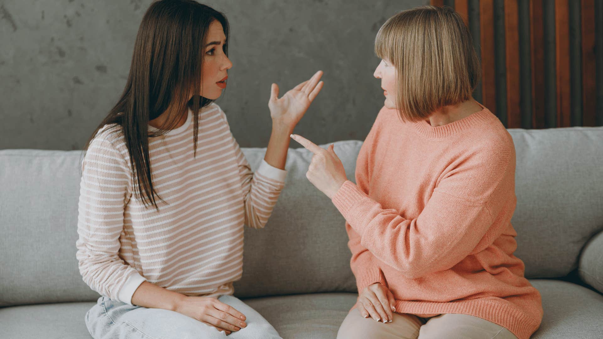 mother yelling at daughter on couch