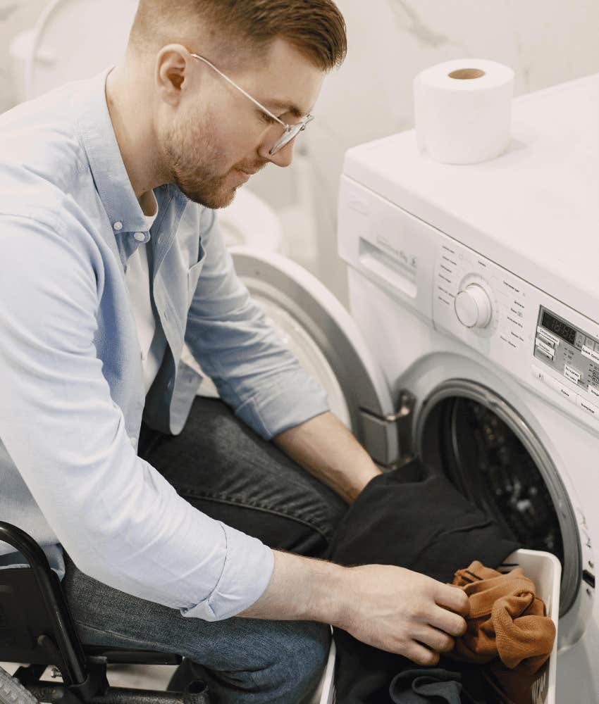 man leaving washing machine door open so it doesn't make him sick