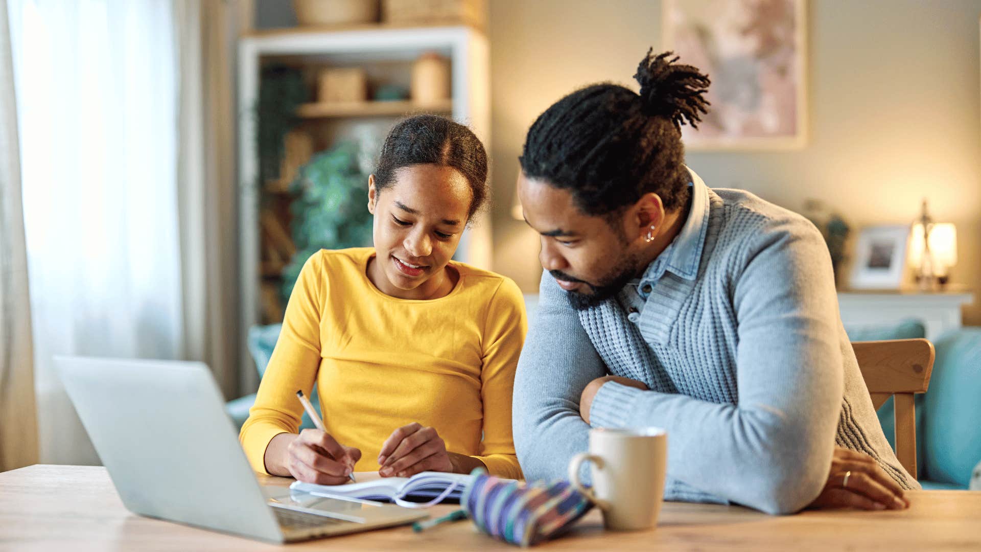 father helping daughter with homework