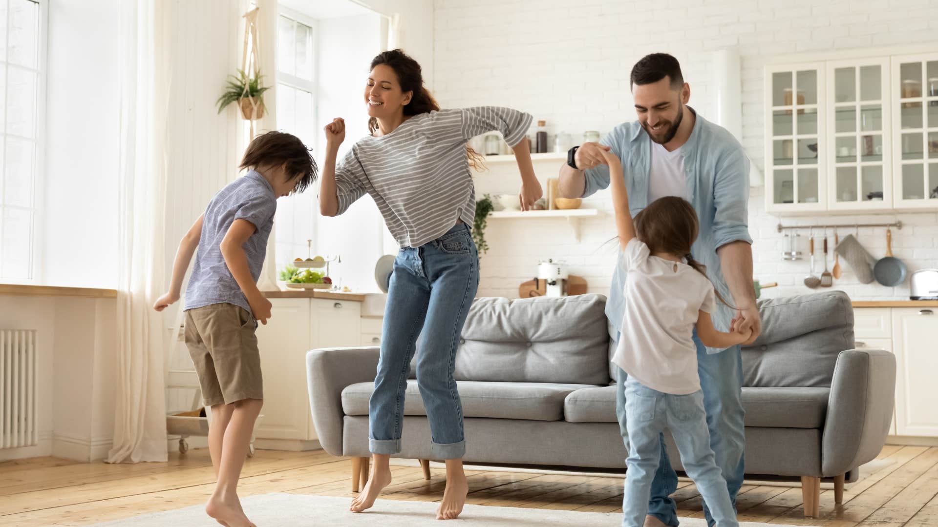 happy family dancing in the living room