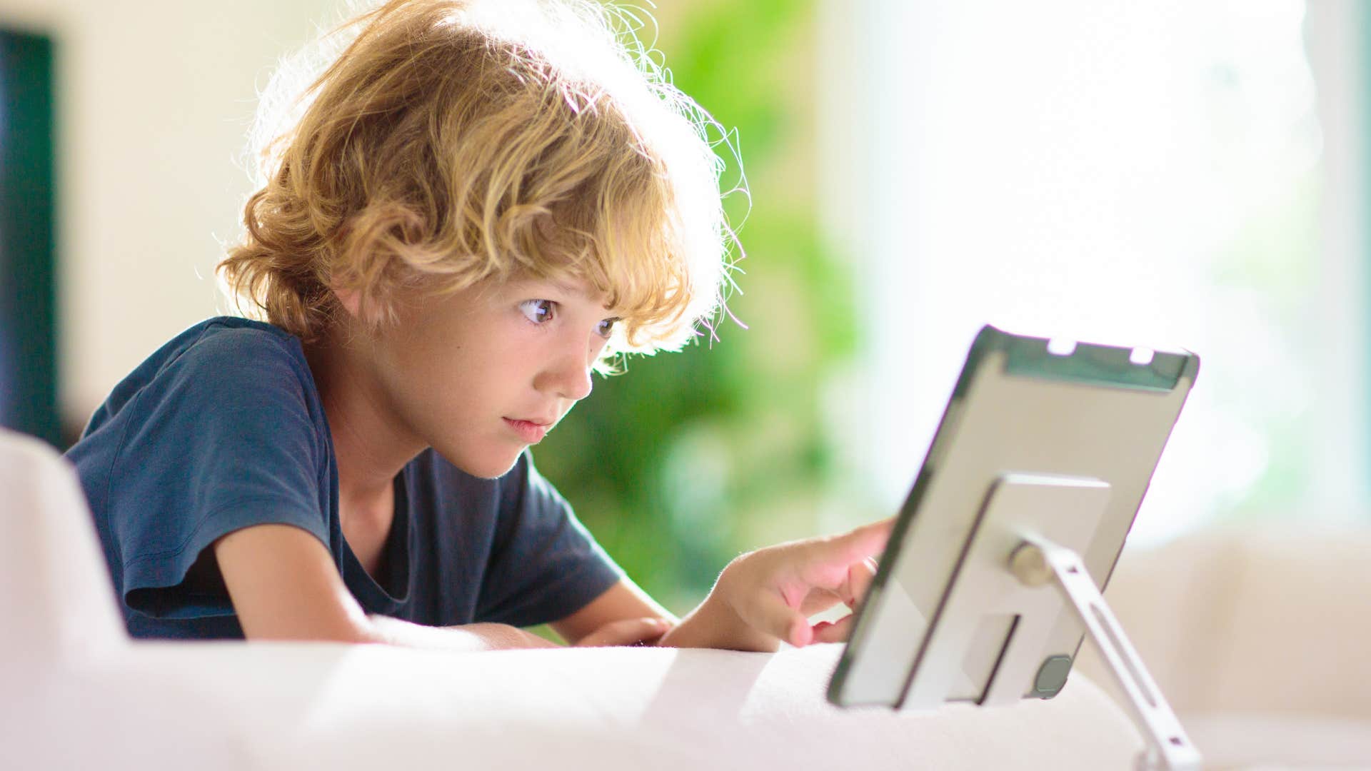 kid distracted on a tablet