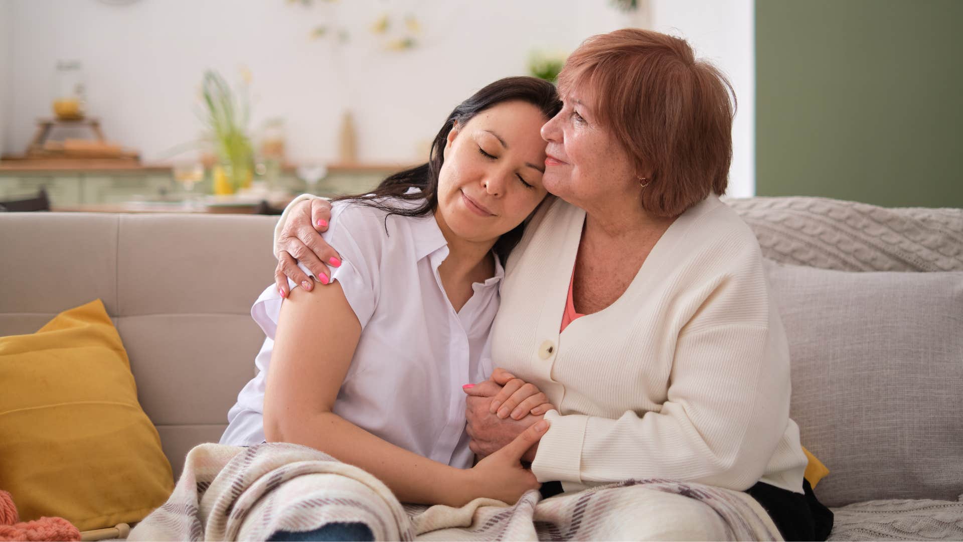 woman leaning on her mom smiling